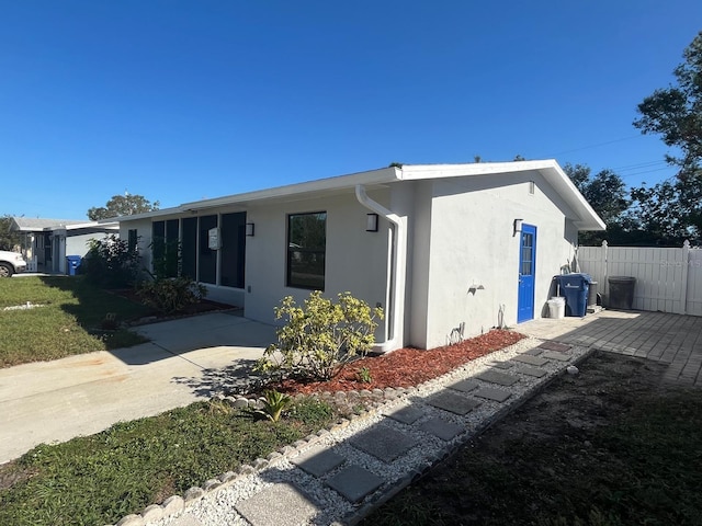 view of side of property with a patio