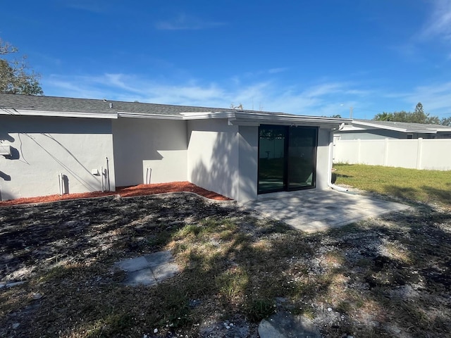 back of property featuring a lawn and a patio area