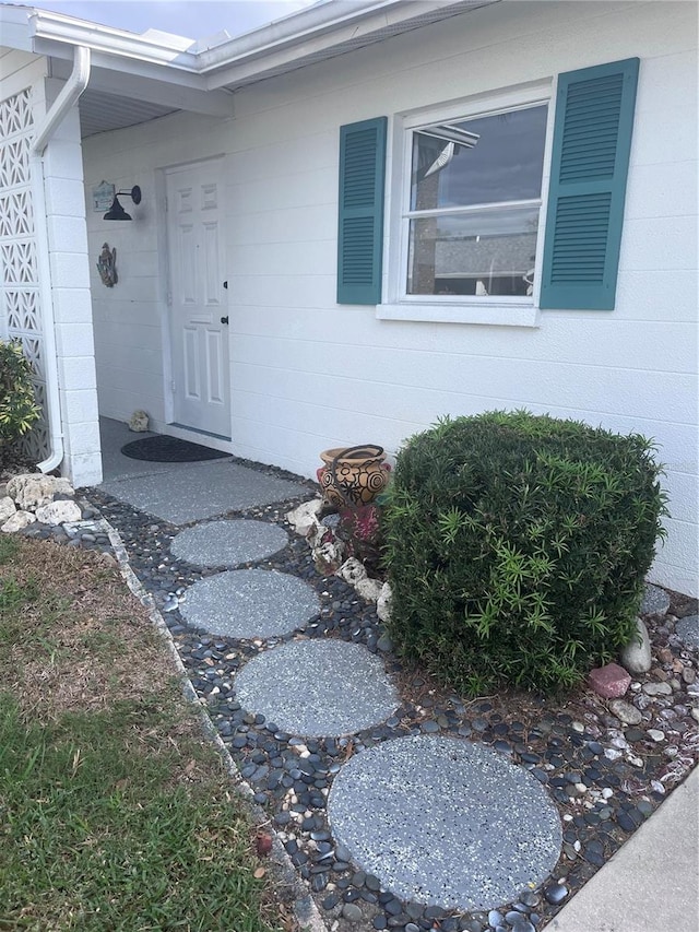 view of exterior entry with concrete block siding