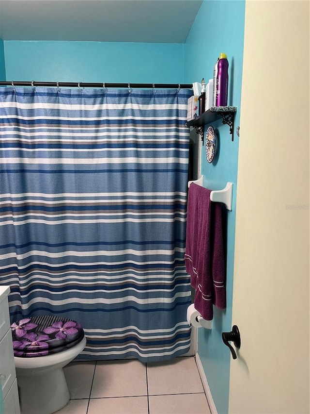 bathroom featuring tile patterned flooring and toilet