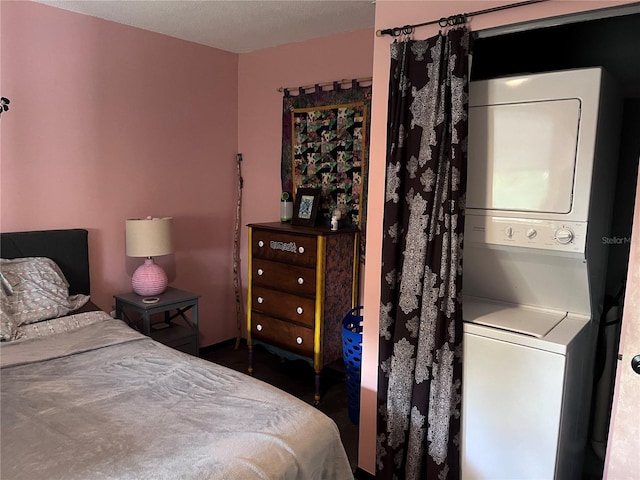 bedroom featuring stacked washer and dryer