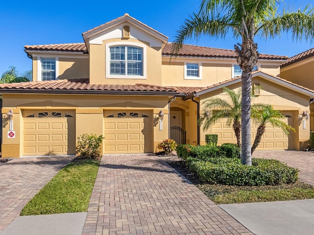 8133 Miramar Way Unit 201, Lakewood Ranch, FL 34202 - view of front facade with driveway, stucco siding, and a tiled roof