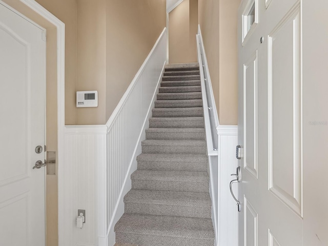8133 Miramar Way Unit 201, Lakewood Ranch, FL 34202 - stairway with a wainscoted wall, a decorative wall, and carpet floors