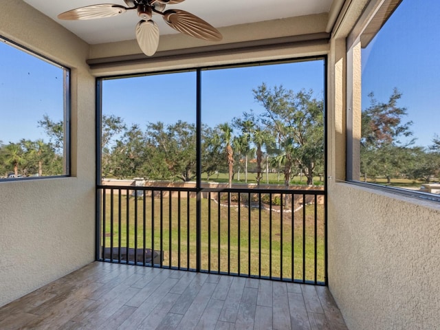 8133 Miramar Way Unit 201, Lakewood Ranch, FL 34202 - unfurnished sunroom featuring a textured wall and wood finished floors