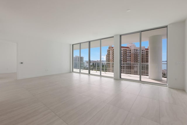 unfurnished room with floor to ceiling windows