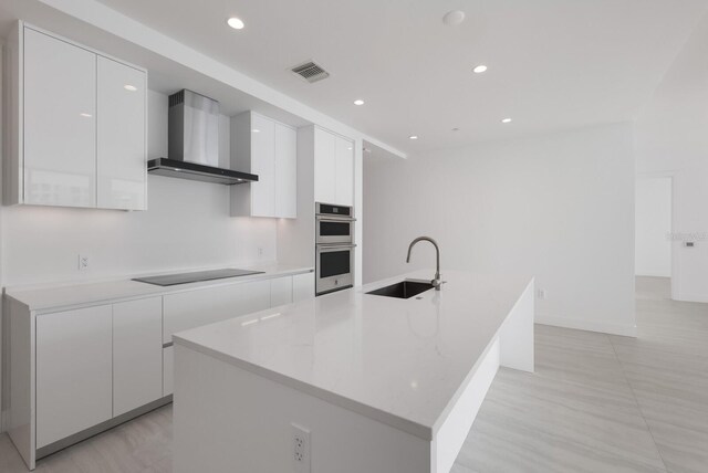 301 Quay Commons Unit 1111, Sarasota, FL 34236 - kitchen with wall chimney exhaust hood, a sink, modern cabinets, white cabinetry, and recessed lighting