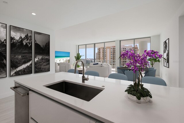 301 Quay Commons Unit 1111, Sarasota, FL 34236 - kitchen with a sink, light countertops, light wood finished floors, open floor plan, and recessed lighting