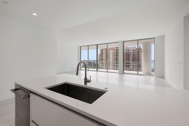 301 Quay Commons Unit 1111, Sarasota, FL 34236 - kitchen featuring a sink, light countertops, recessed lighting, and baseboards