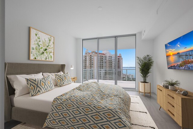 301 Quay Commons Unit 1111, Sarasota, FL 34236 - bedroom with expansive windows and access to outside