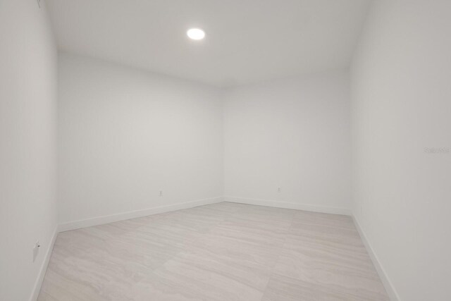 301 Quay Commons Unit 1111, Sarasota, FL 34236 - empty room with baseboards and recessed lighting