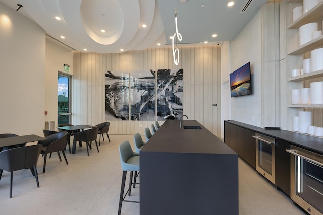 301 Quay Commons Unit 1111, Sarasota, FL 34236 - kitchen with modern cabinets, dark countertops, a sink, wine cooler, and recessed lighting