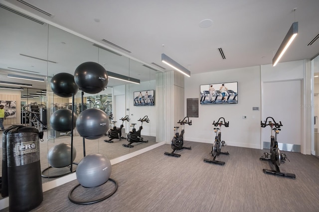 301 Quay Commons Unit 1111, Sarasota, FL 34236 - gym featuring wood finished floors