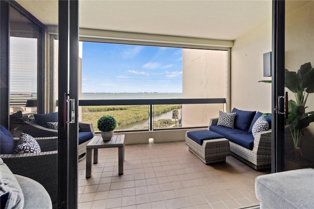 sunroom featuring plenty of natural light and a water view