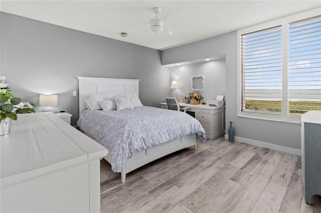 bedroom featuring light hardwood / wood-style floors and ceiling fan