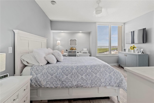 bedroom featuring light wood-type flooring and ceiling fan