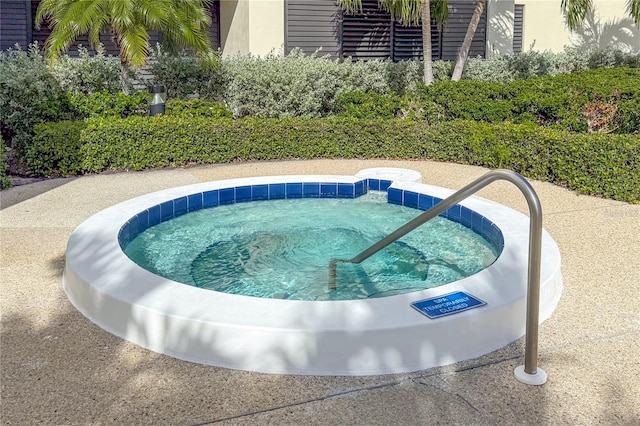 view of swimming pool featuring a community hot tub