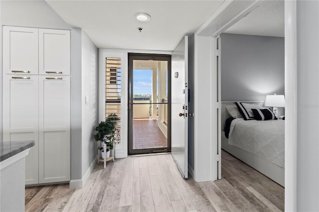 corridor with light hardwood / wood-style flooring