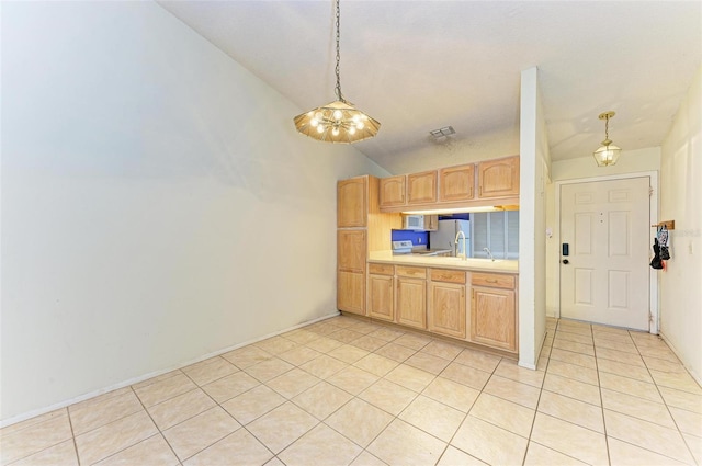 kitchen with vaulted ceiling, pendant lighting, light brown cabinets, white fridge, and light tile patterned flooring