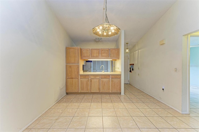 kitchen featuring sink, an inviting chandelier, high vaulted ceiling, decorative light fixtures, and light brown cabinetry