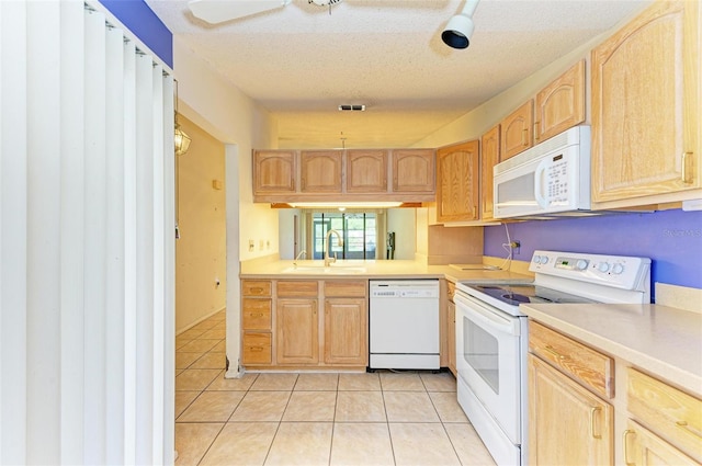 kitchen featuring light tile patterned floors, white appliances, a textured ceiling, and sink