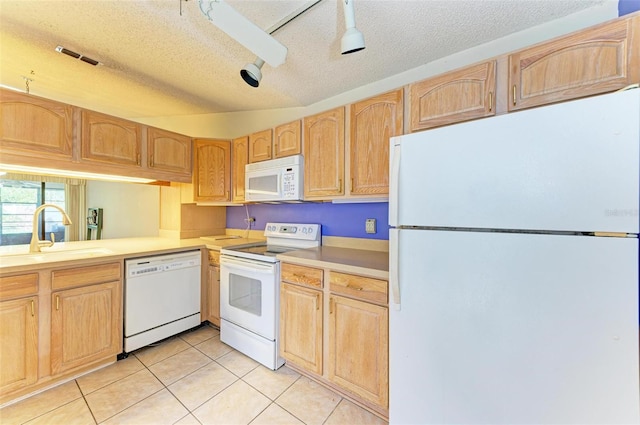 kitchen featuring a textured ceiling, white appliances, light brown cabinetry, and sink