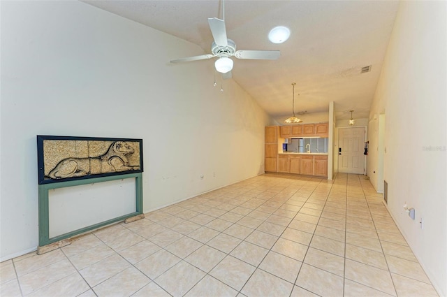 unfurnished living room featuring ceiling fan, light tile patterned flooring, and lofted ceiling