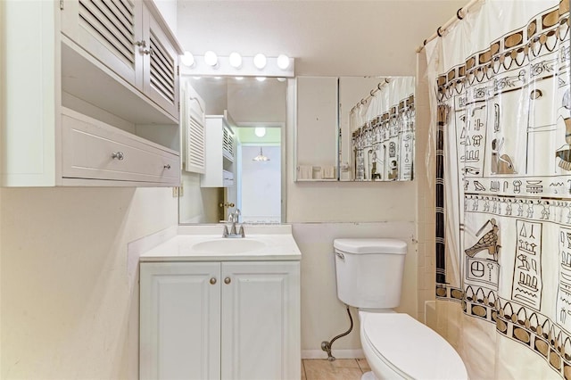 bathroom with tile patterned floors, vanity, and toilet