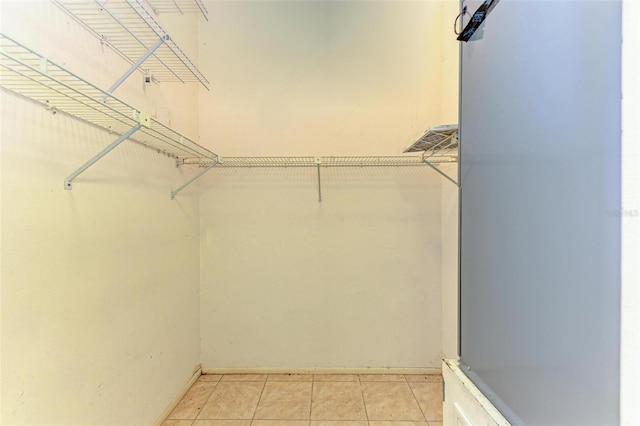 spacious closet featuring light tile patterned floors