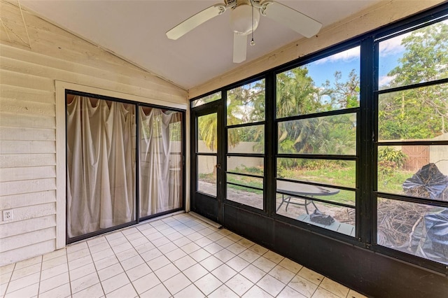 unfurnished sunroom with a wealth of natural light, ceiling fan, and lofted ceiling