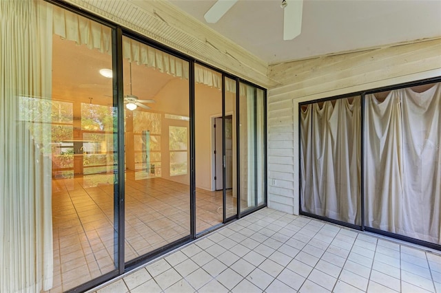 unfurnished sunroom featuring ceiling fan