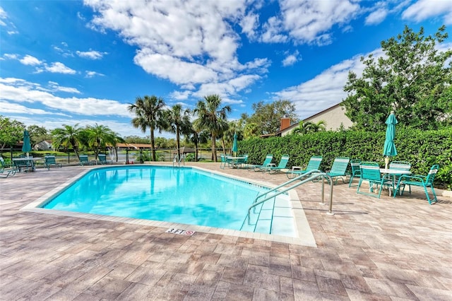 view of swimming pool featuring a patio