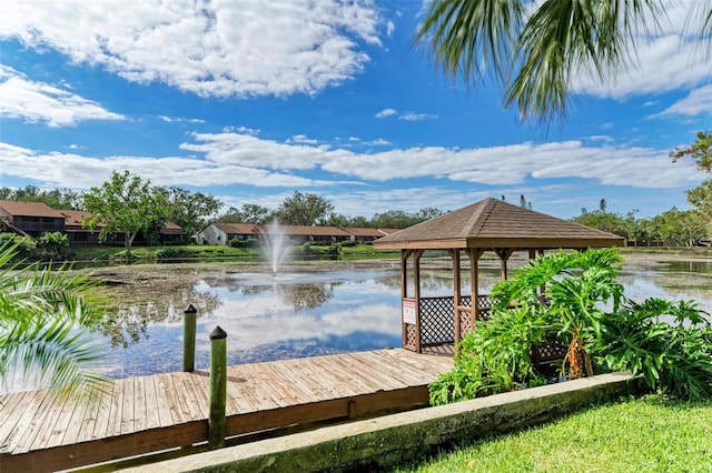 view of dock with a gazebo and a water view