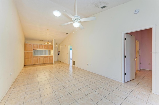 unfurnished living room with a textured ceiling, ceiling fan, sink, light tile patterned floors, and high vaulted ceiling