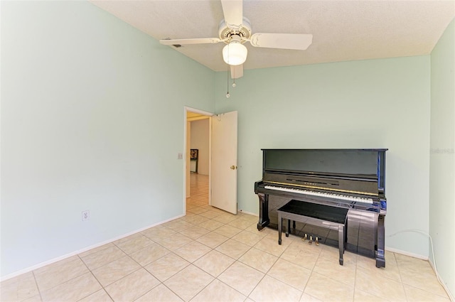 miscellaneous room with a textured ceiling, ceiling fan, and light tile patterned flooring