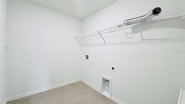 laundry area featuring hookup for an electric dryer, light tile patterned floors, and washer hookup