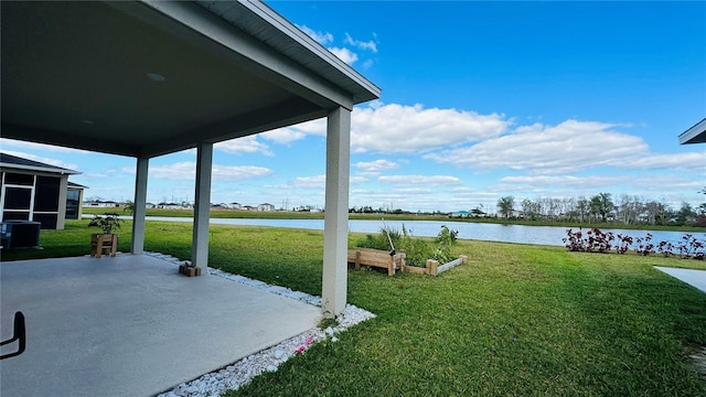 view of yard featuring a water view, a patio, and central AC unit