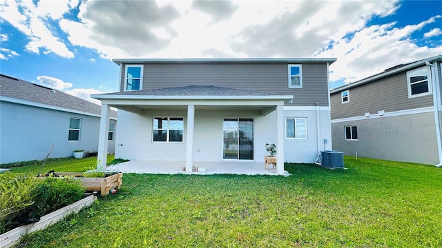 back of property with a yard, a patio, and central AC unit