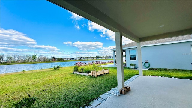 view of yard featuring a patio area and a water view