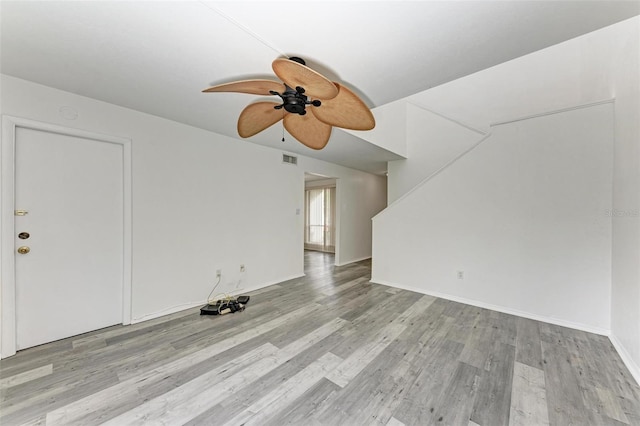 unfurnished living room with ceiling fan and light hardwood / wood-style flooring