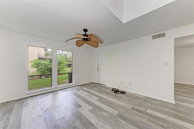 empty room featuring ceiling fan and light hardwood / wood-style floors