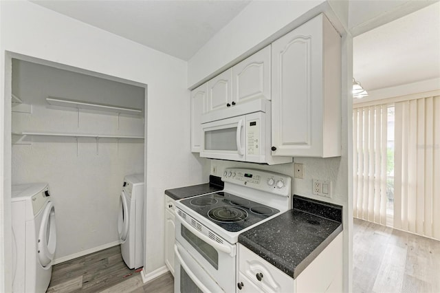 kitchen with hardwood / wood-style flooring, white cabinetry, washing machine and dryer, and white appliances