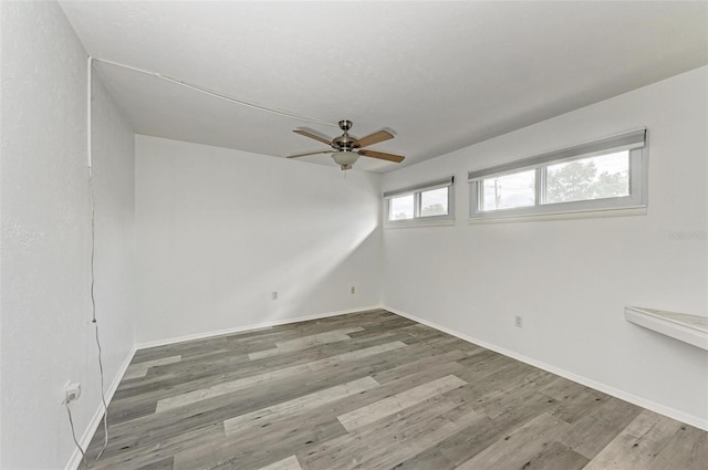 unfurnished room featuring hardwood / wood-style flooring and ceiling fan