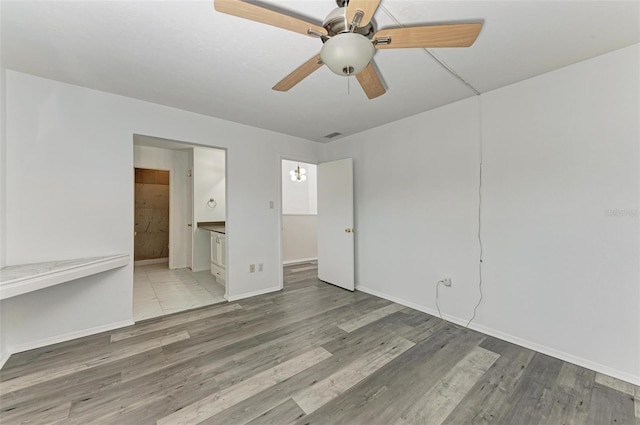 unfurnished room with ceiling fan and wood-type flooring