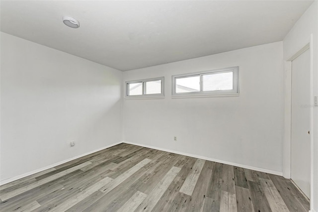 unfurnished room with hardwood / wood-style flooring