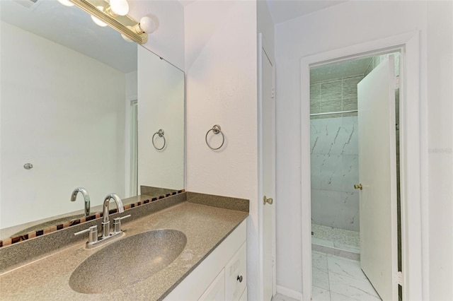 bathroom with vanity and tiled shower