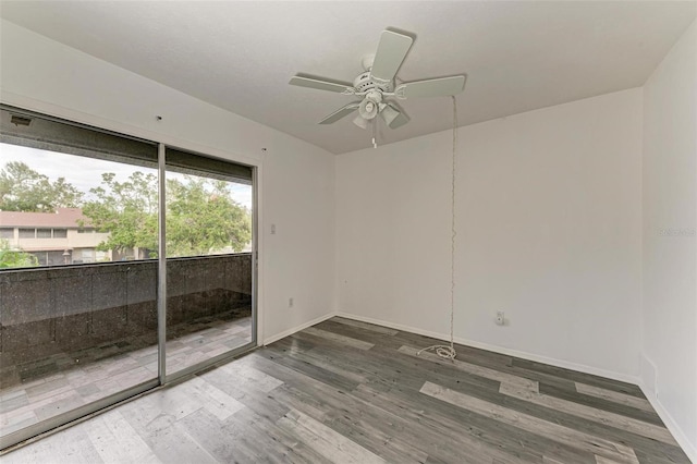 unfurnished room with ceiling fan and dark wood-type flooring