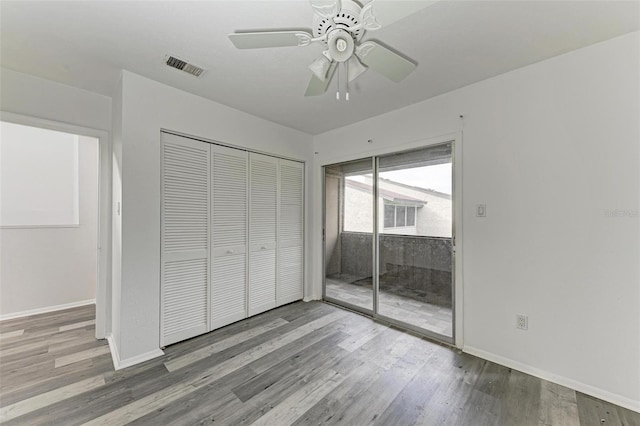 unfurnished bedroom featuring ceiling fan, a closet, and light hardwood / wood-style floors