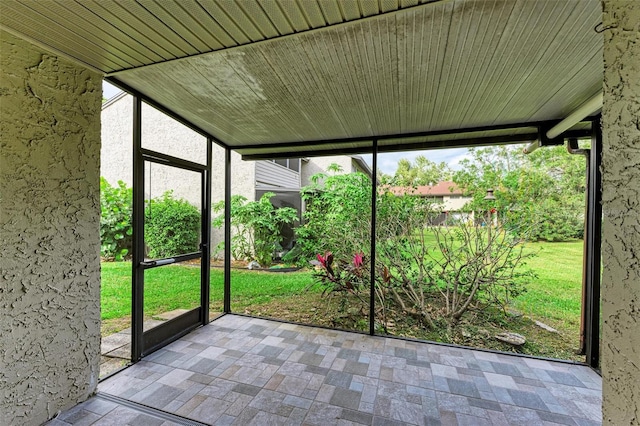 unfurnished sunroom featuring a wealth of natural light and wooden ceiling