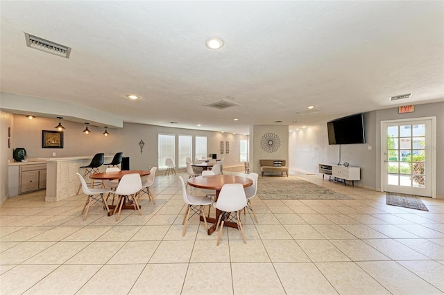 tiled dining room featuring a textured ceiling