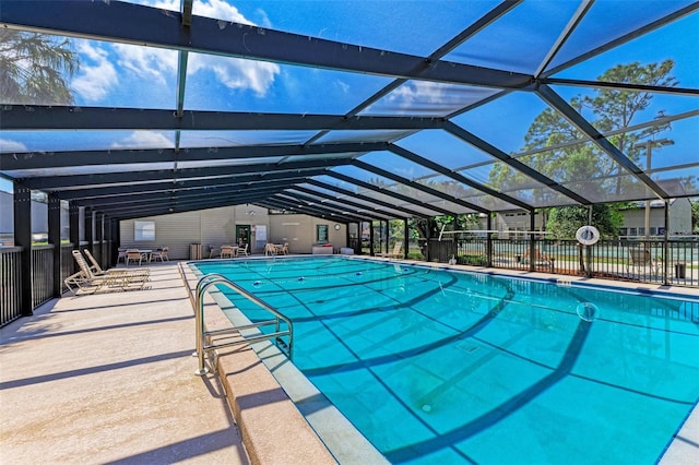 view of swimming pool featuring a patio area and a lanai